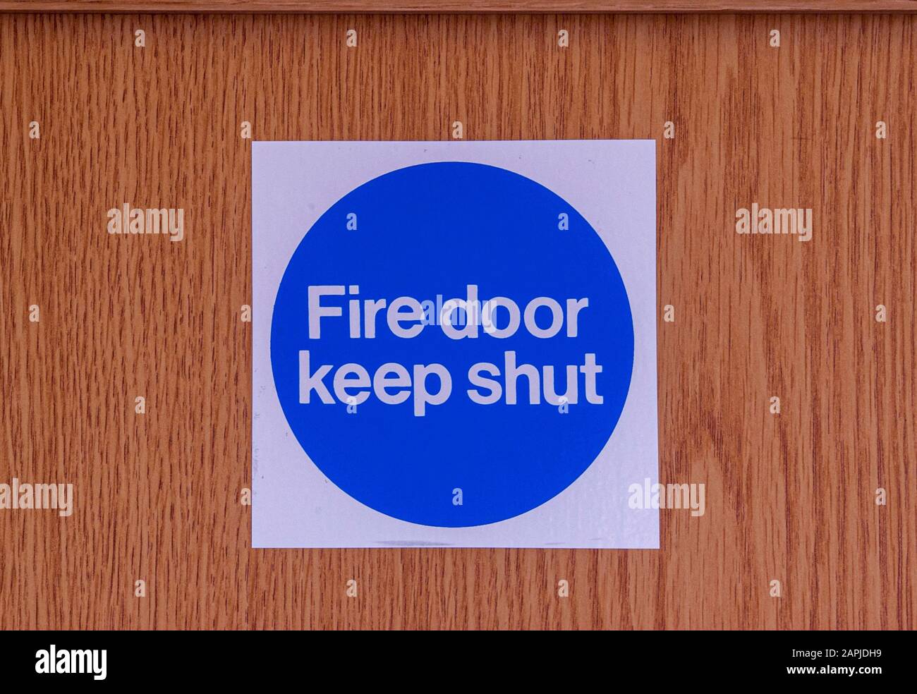 Fire door Keep Shut sign on wooden door Stock Photo
