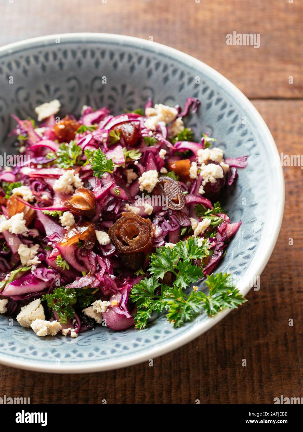 Red Cabbage Slaw with Dates and home made Vegan feta. Stock Photo