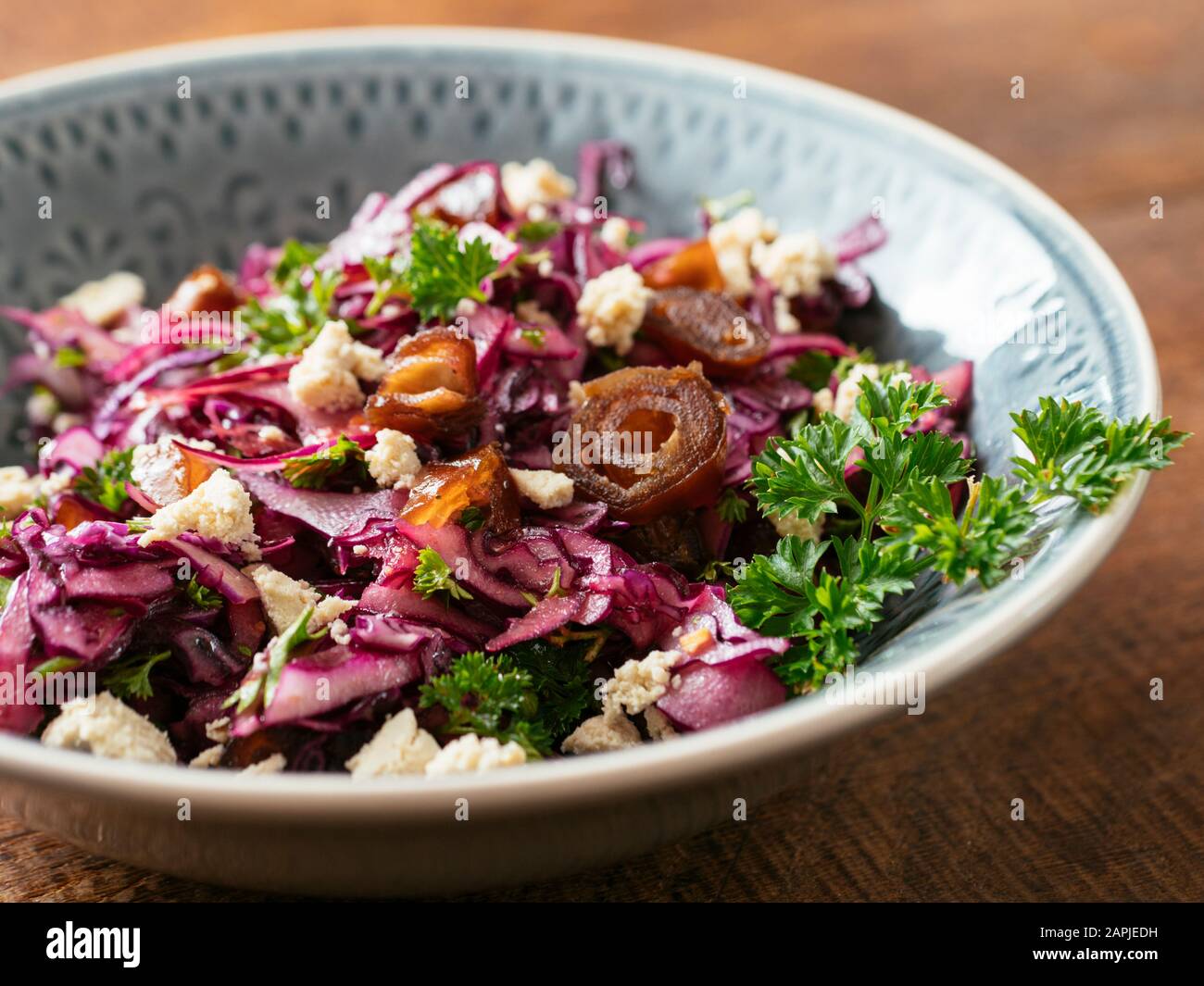 Red Cabbage Slaw with Dates and home made Vegan feta. Stock Photo