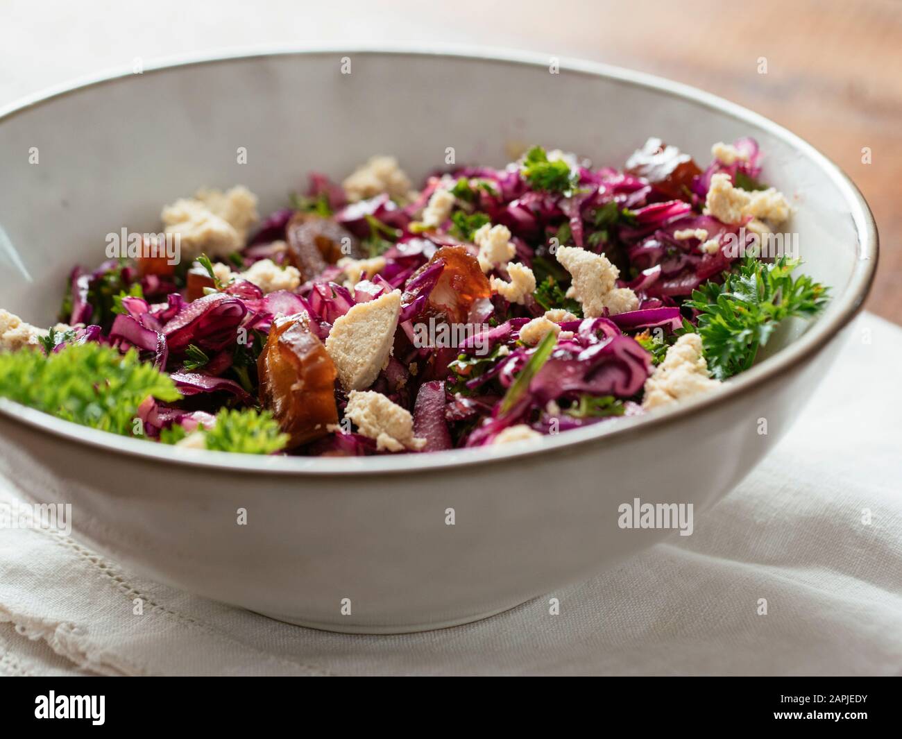 Red Cabbage Slaw with Dates and home made Vegan feta. Stock Photo