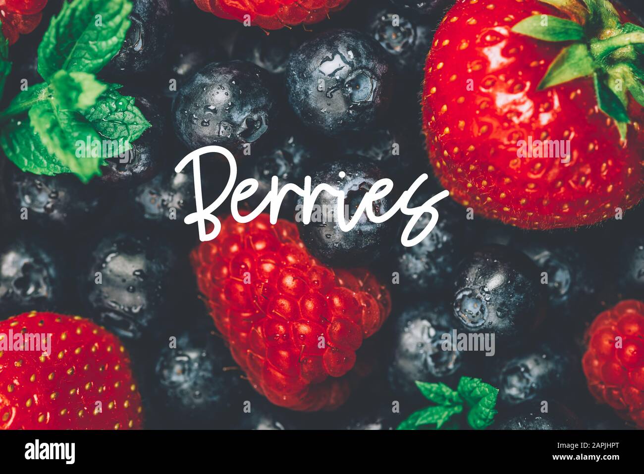 Fresh summer berries such as blueberries, strawberries, raspberries with slogan Berries, top view Stock Photo