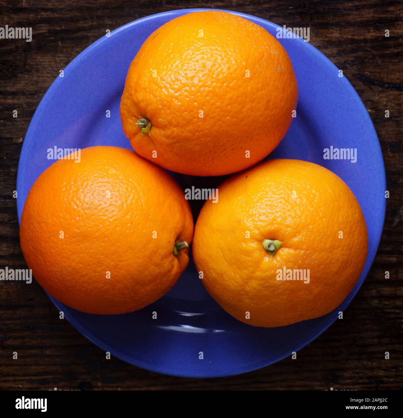 Arrangement of whole oranges on dark background.  Small group of objects. Stock Photo