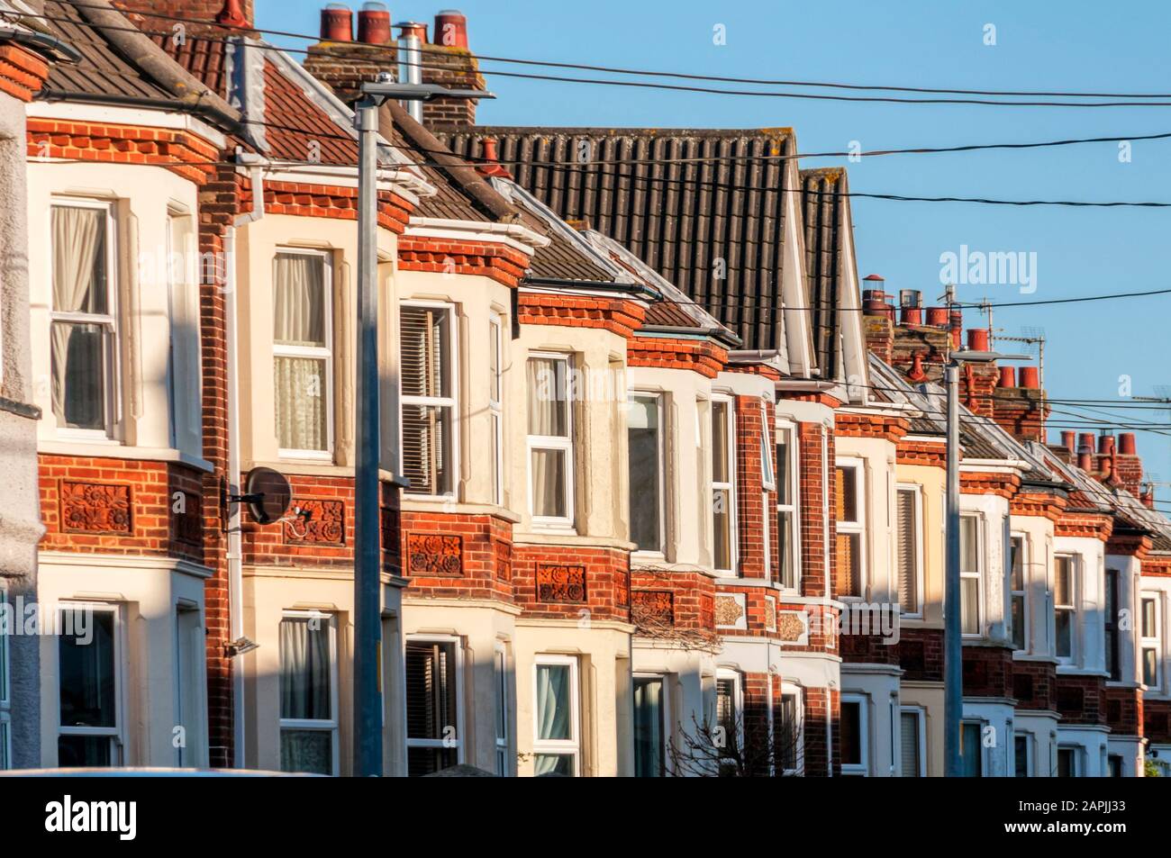 Evening sun lighting up the fronts of terraced Edwardian houses in Hunstanton, Norfolk. Stock Photo