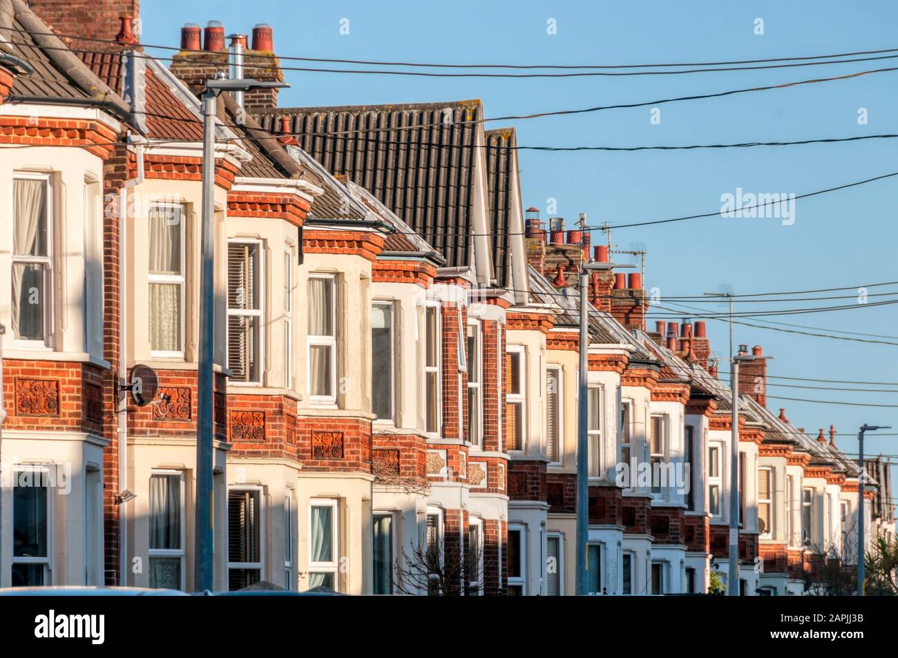 Evening sun lighting up the fronts of terraced Edwardian houses in Hunstanton, Norfolk. Stock Photo