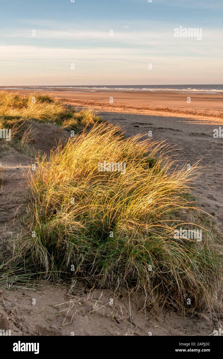 Late afternoon sunlight on Brancaster beach on the North Norfolk coast. Stock Photo
