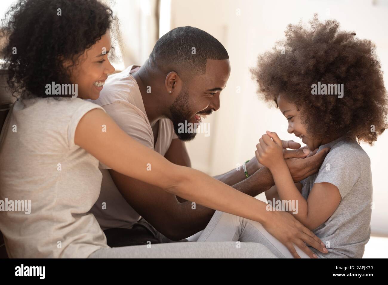 African family with little daughter playing at home Stock Photo