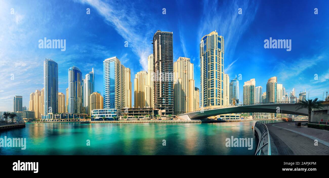 Dubai Marina under the blue sky, with the skyline and clear turquoise water, panorama shot Stock Photo