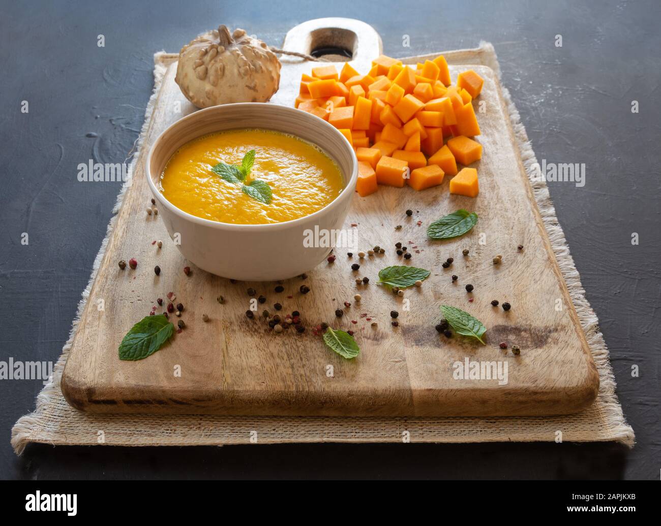 Pumpkin cream, sliced pumpkin ingredients, rustic background, food style Stock Photo