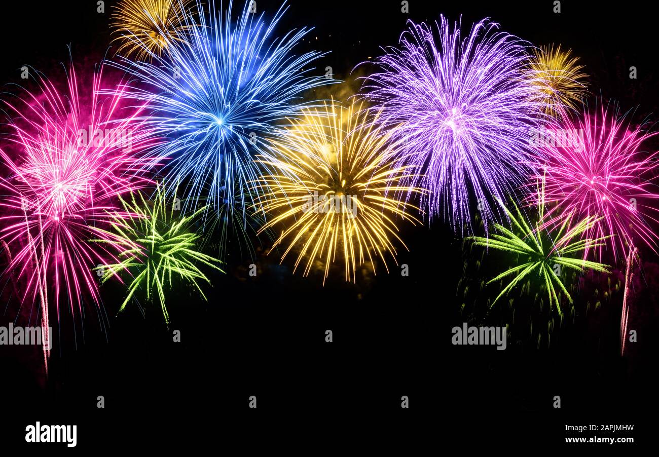 Colorful fireworks shaped like an arch with black copy space underneath Stock Photo