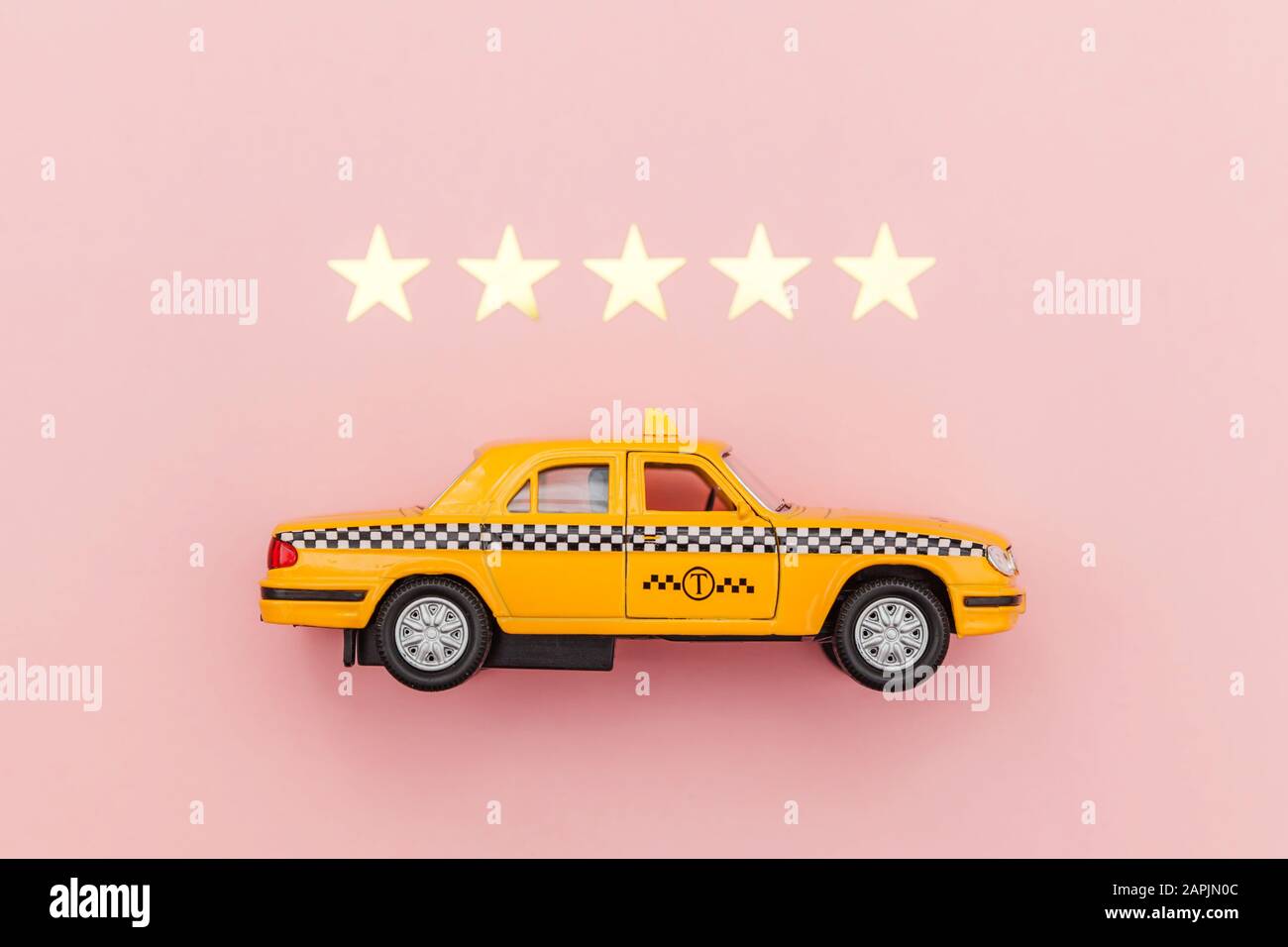Yellow Toy Car Taxi Cab And 5 Stars Rating Isolated On Pink