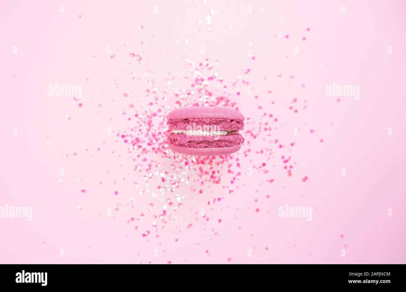 Macaroon on glitter pink pastel background. Flat lay Stock Photo