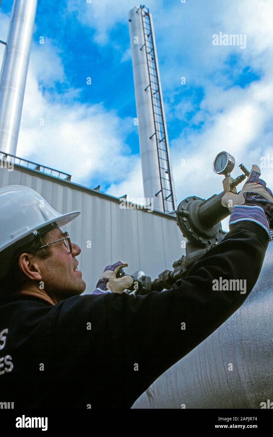 Oil and gas technician checking gauges at an oil field Stock Photo Alamy