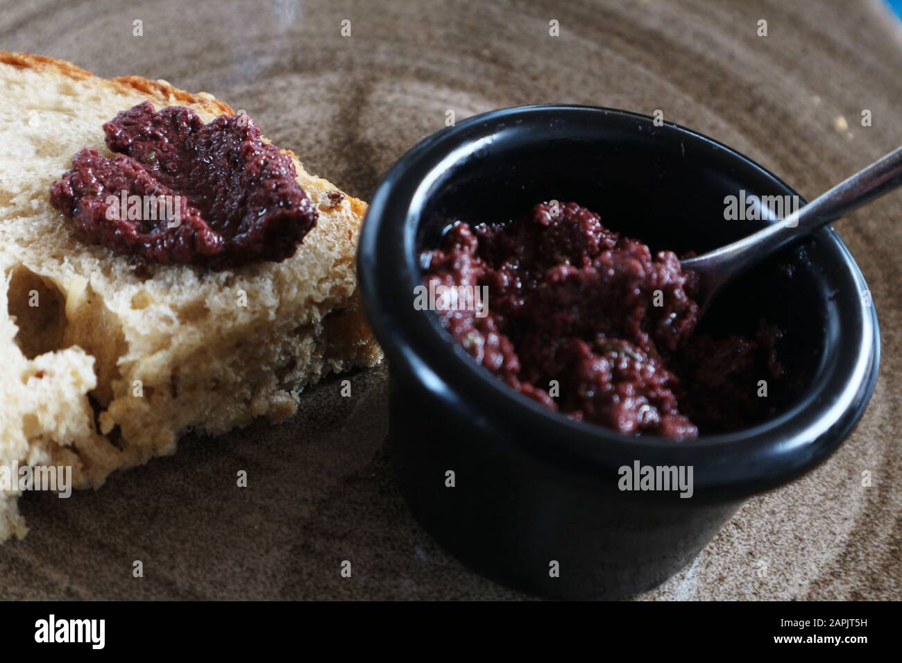 Black olive paste pesto with sesame bread hires stock photography and