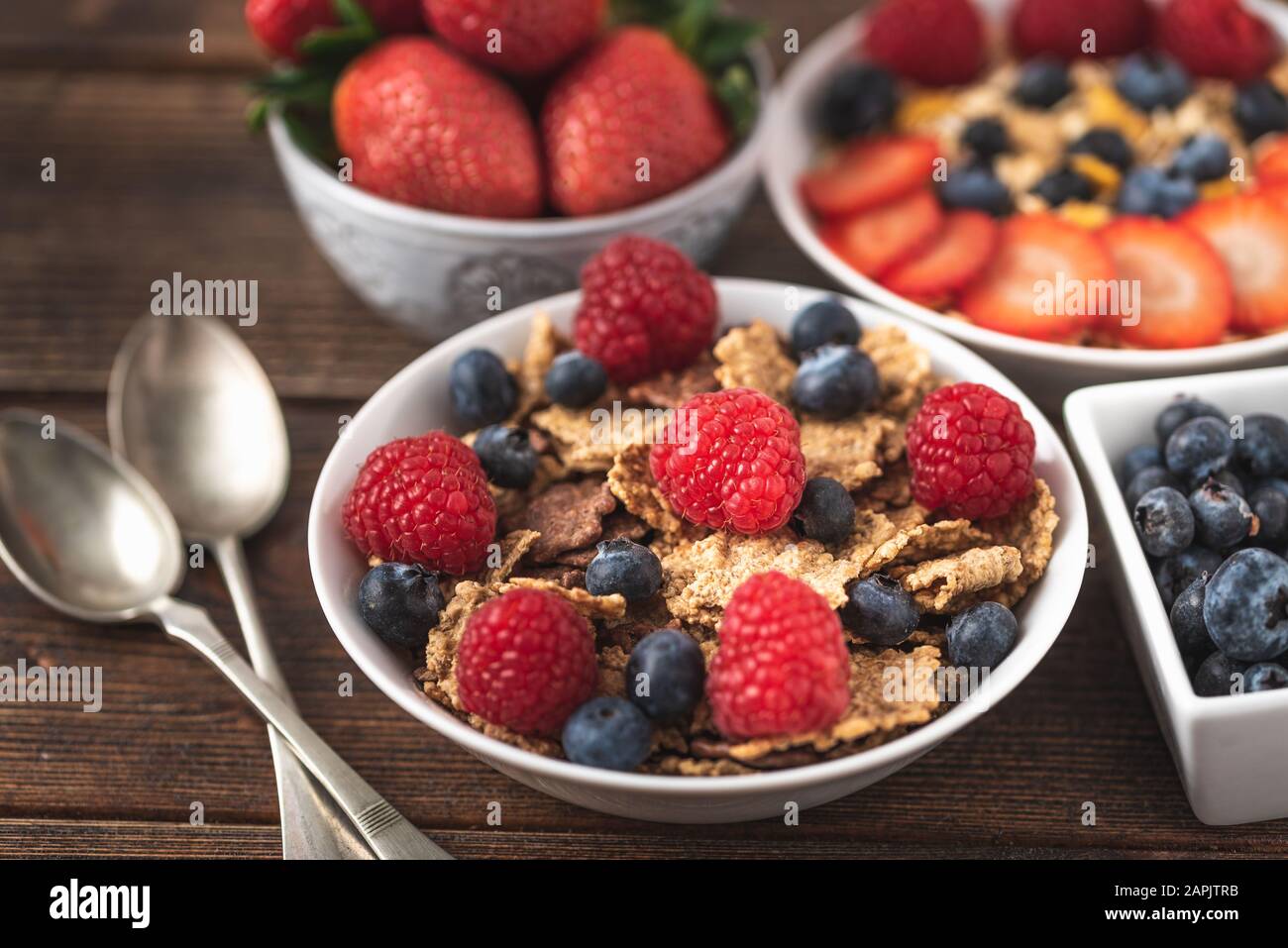 Granola chips with blueberries and raspberries in white bowl Stock