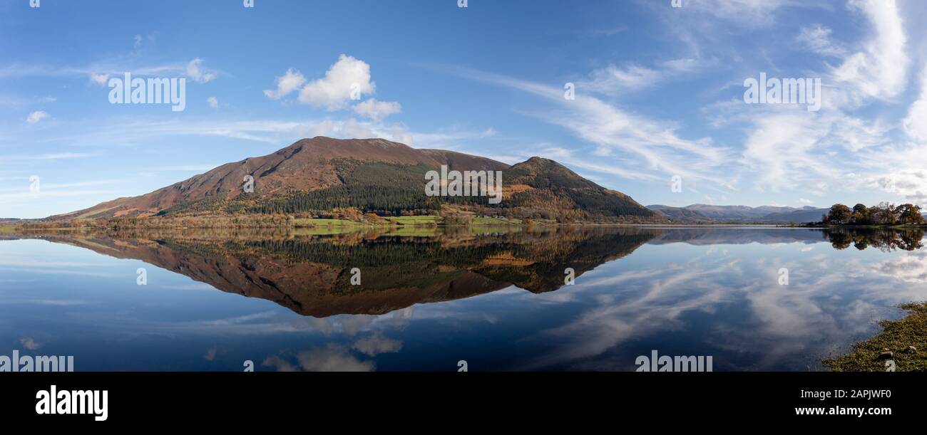 bassenthwaite and skiddaw panorama with reflection in calm water blue sky and clouds Stock Photo