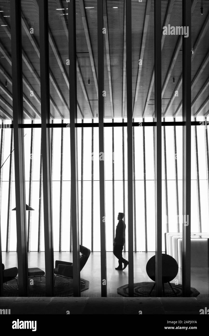 London black and white street photography: single figure in modern office building, City of London, UK Stock Photo