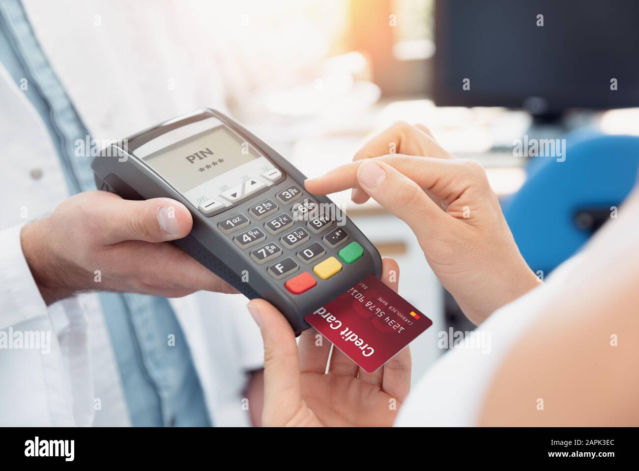 Payment by credit card with terminal. Woman enters the pin code Stock Photo
