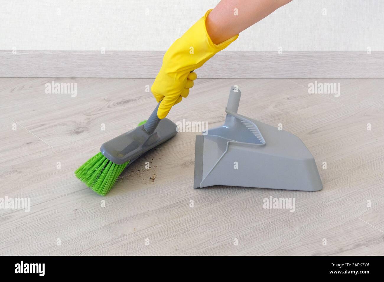 Cleaning Concept Female Hand In Yellow Rubber Glove Sweeping