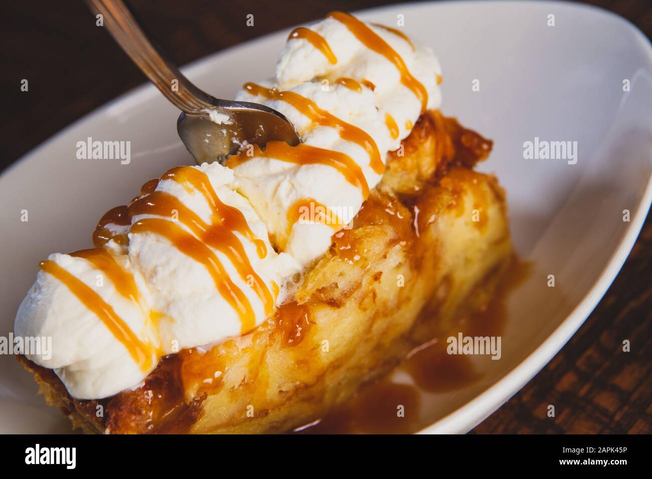 Bread pudding dessert sitting on a wooden table. Stock Photo