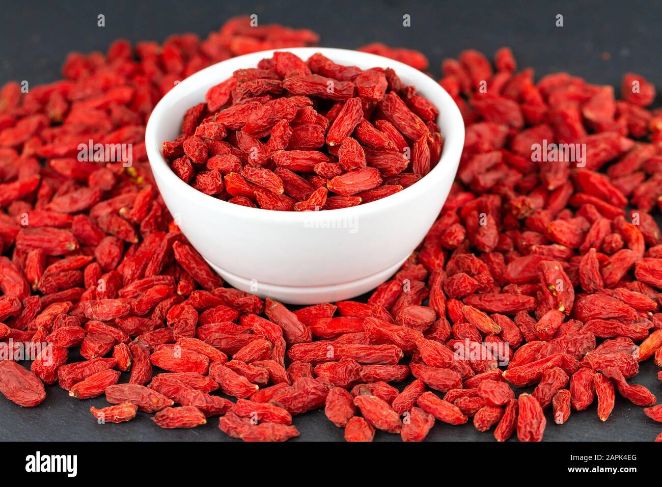 Closeup of goji berry in a white cup. Selective focus Stock Photo