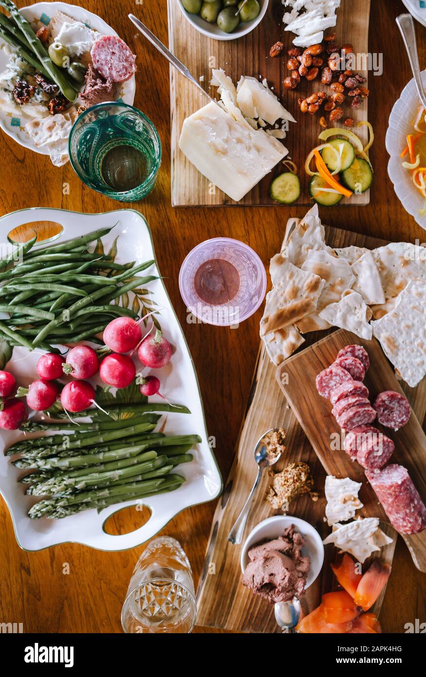 Spread of appetizers on wooden cutting boards and table. Stock Photo