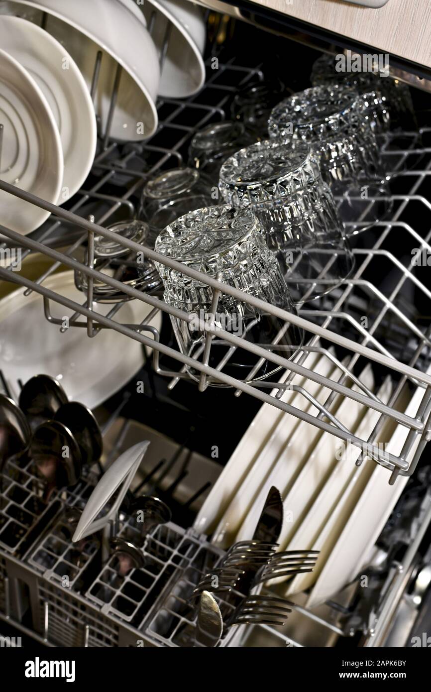 The washed dishes in the dishwasher on the side of the cart are on two