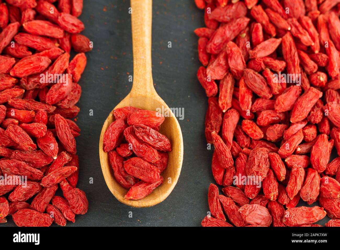 Goji berries over gray slate background. Healthy food concept. Stock Photo