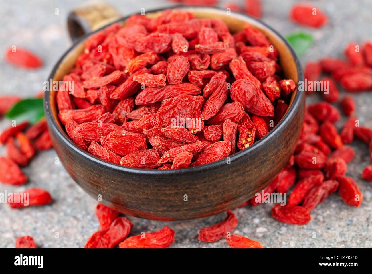 Cup with dried goji berry in close-up. Selective focus, above view Stock Photo
