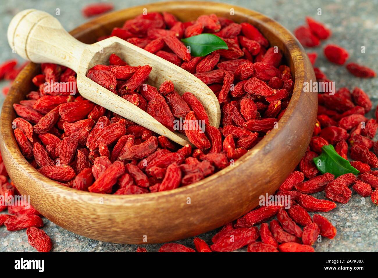 Close up of dried goji berries in wooden bowl. Selective focus. Stock Photo