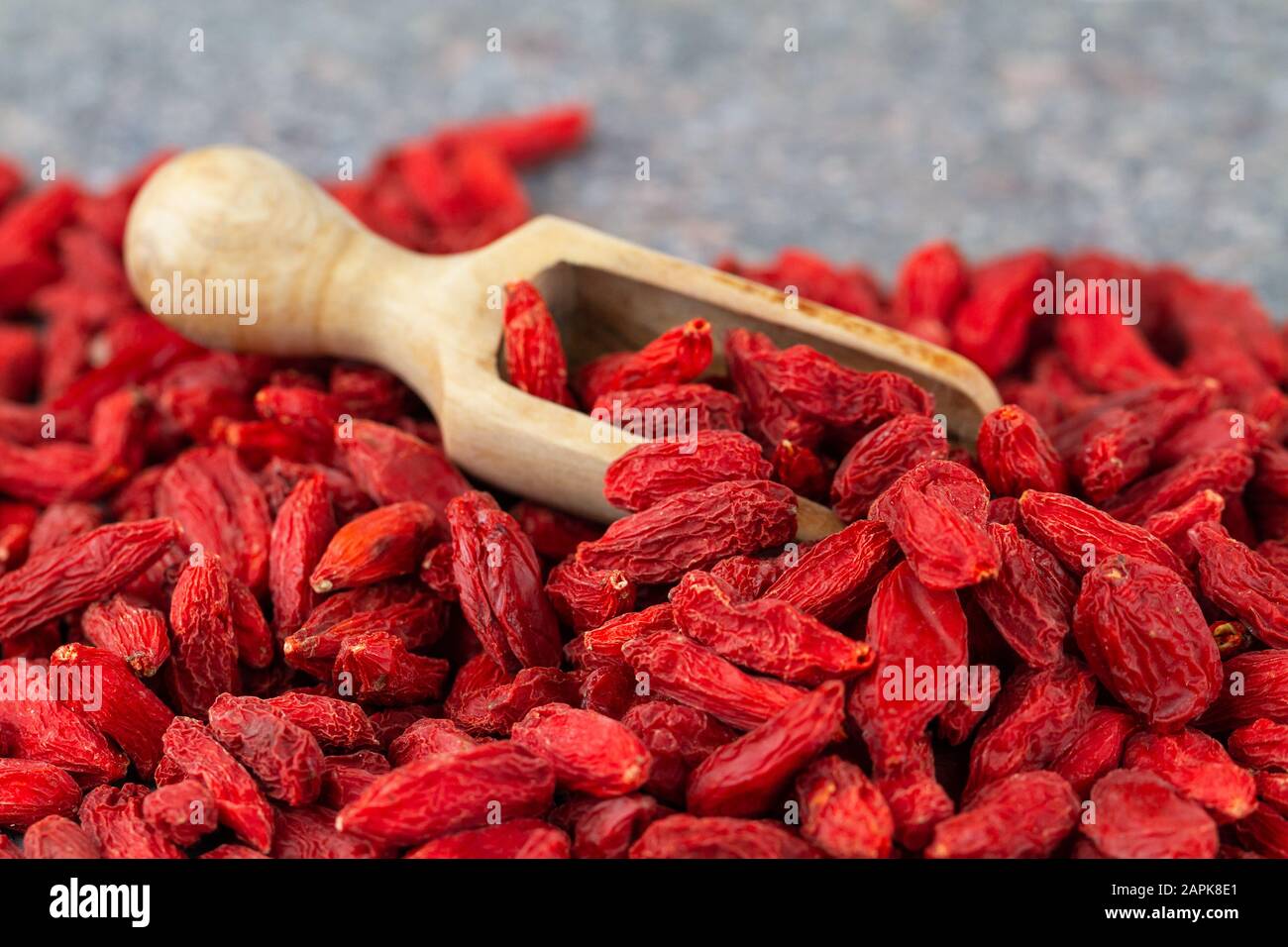 Goji berries close-up. Scoop with dried gougizi berries, selective focus. Stock Photo