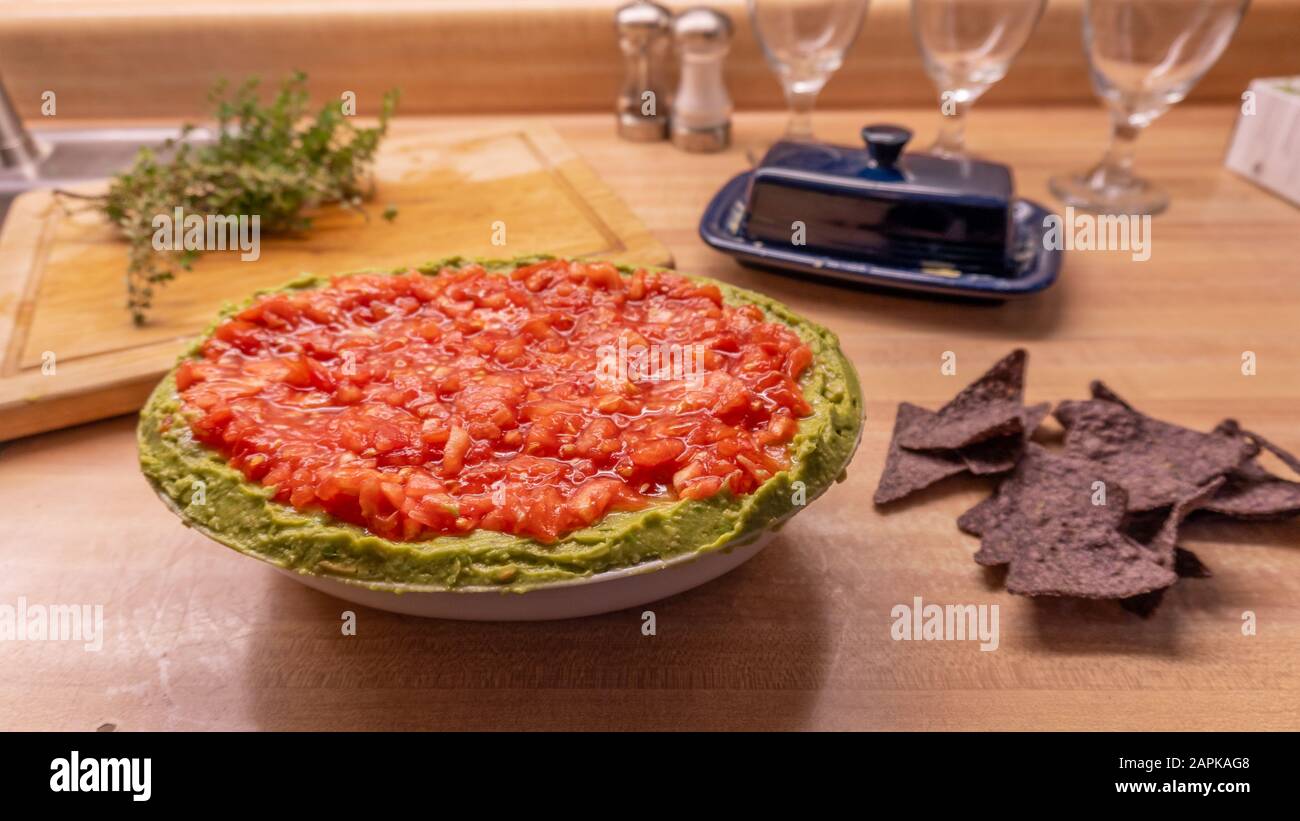 Mexican salsa dip and nacho tortillia chips on a kitchen counter Stock ...