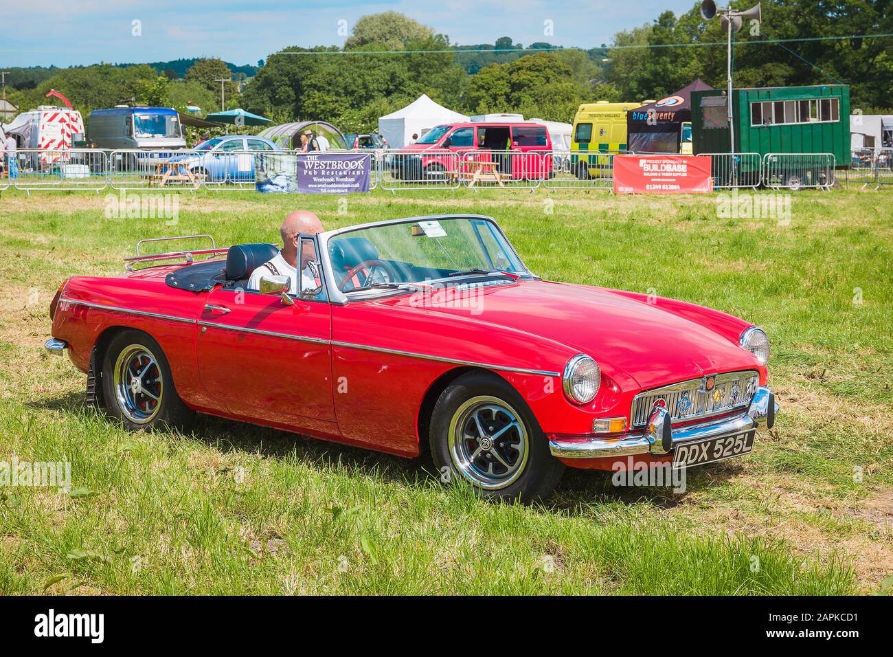 A red open-top MGB British sports car from the 1970s on show at Heddington Country Fair in Wiltshire England UK Stock Photo