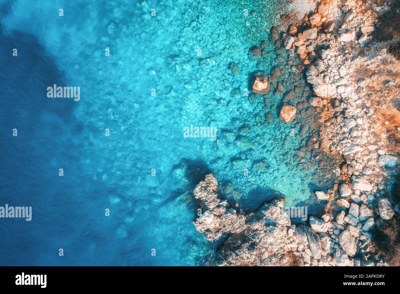 Aerial view of rocky beach and sea with transparent blue water Stock ...