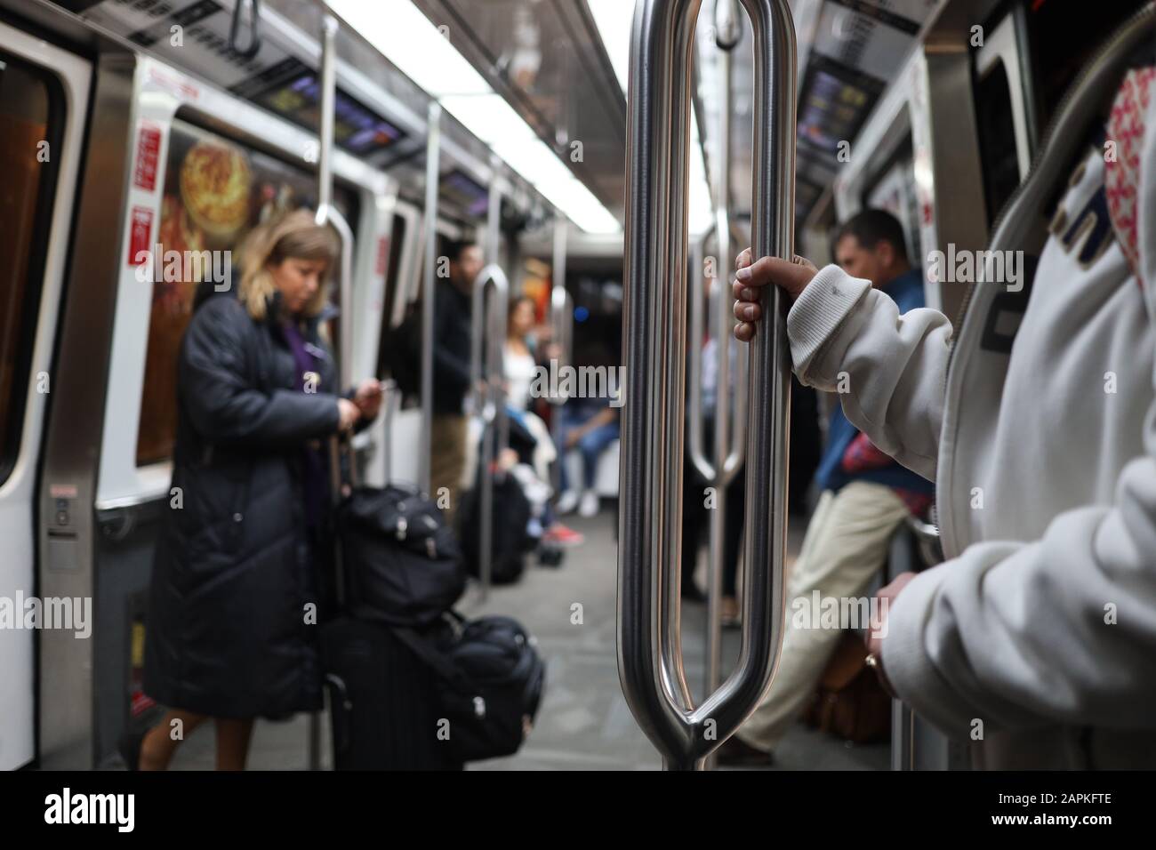 Atlanta, Georgia - December 31, 2019: Unidentified person hand holding the commuter pole in the internal train in the atlanta international airport in Stock Photo