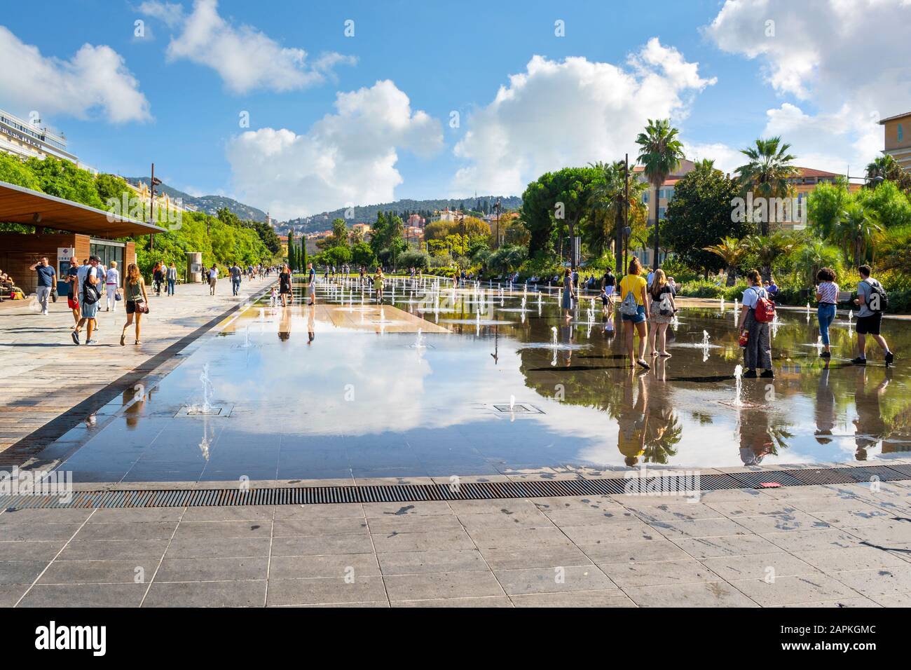 Tourists and local French enjoy a sunny day at Promenade du Paillon ...