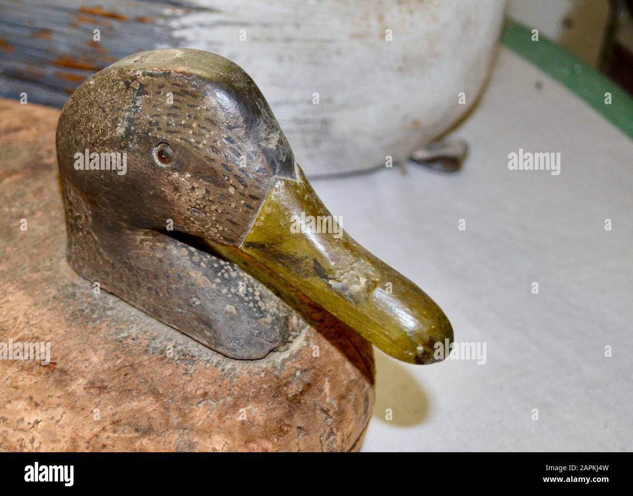 Antique duck decoy with head made of wood and body of cork. Closeup. Copy space. Stock Photo