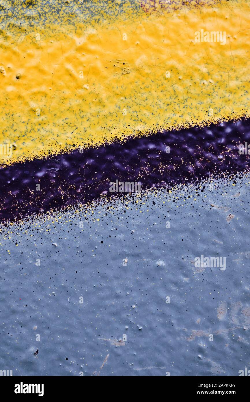 Pale blue, yellow paint and purple line on the wall of plaster. Close