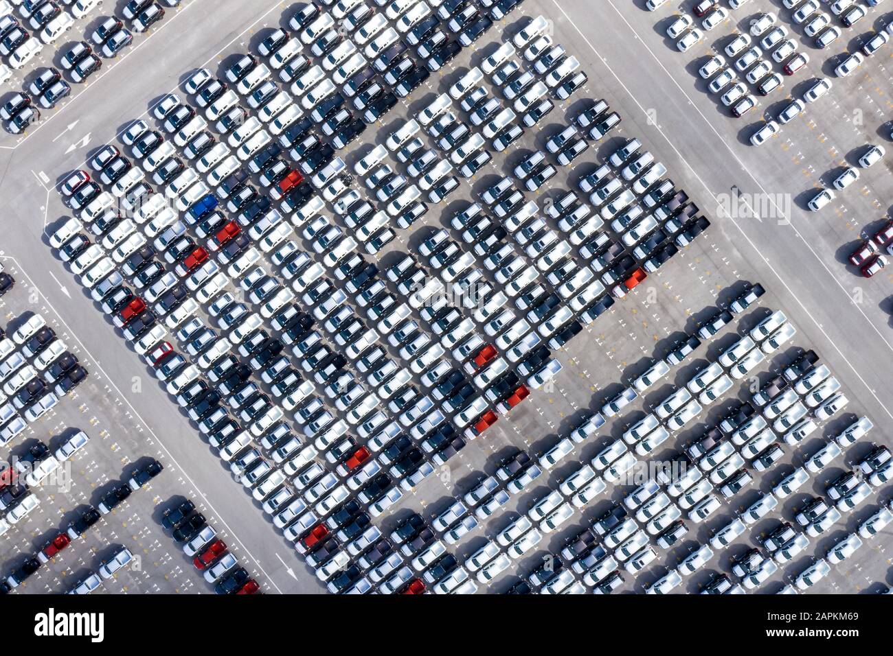 Aerial top view new cars lined up in the port for import export business logistic and transportation by ship in the open sea. New car from the factory Stock Photo