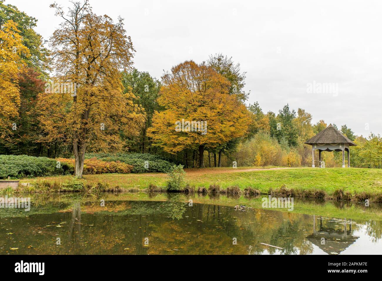 Beautiful view of a park with a gazebo and trees with a peaceful lake ...