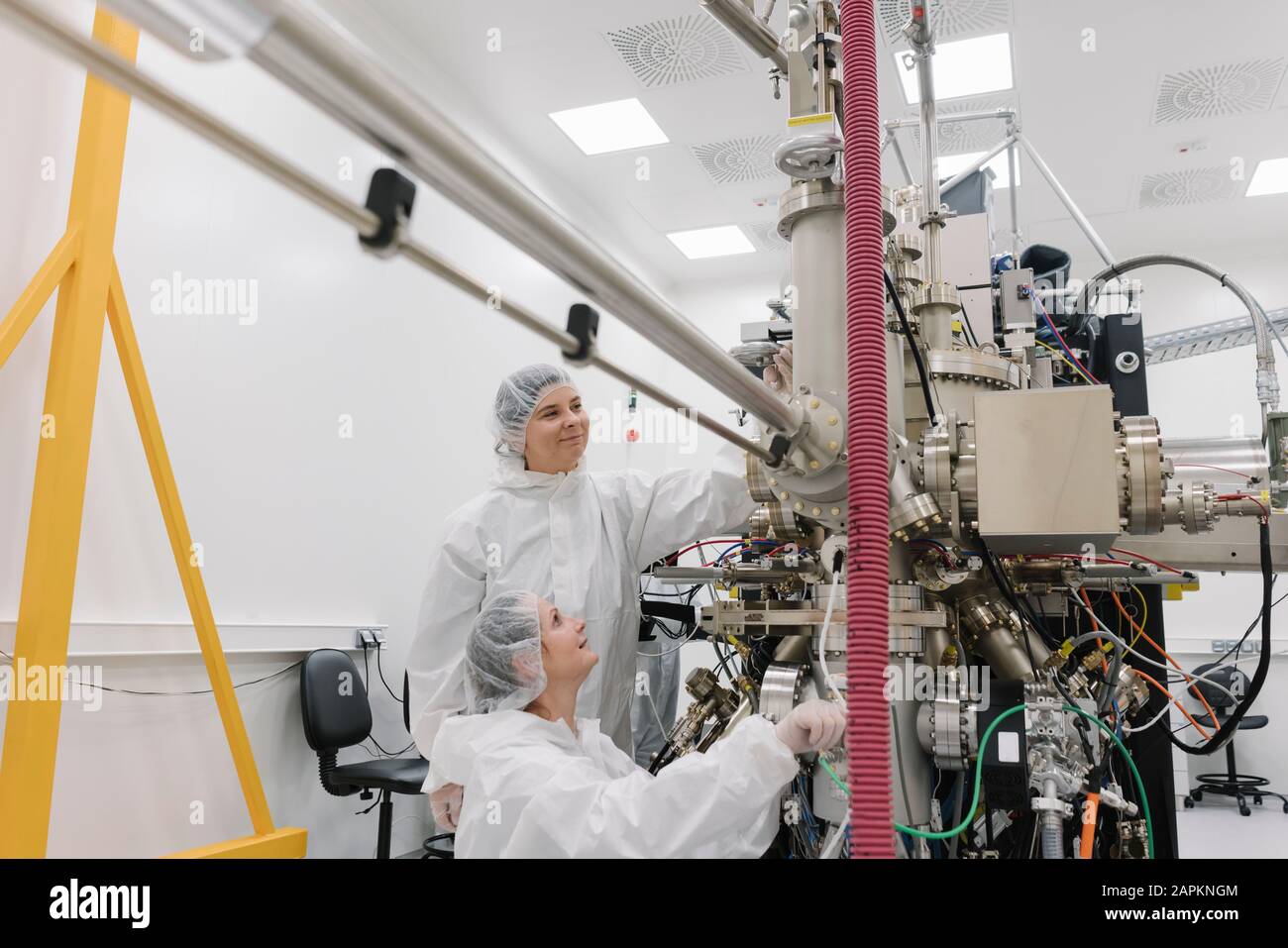 Laboratory technicians working on a device in laboratory of science