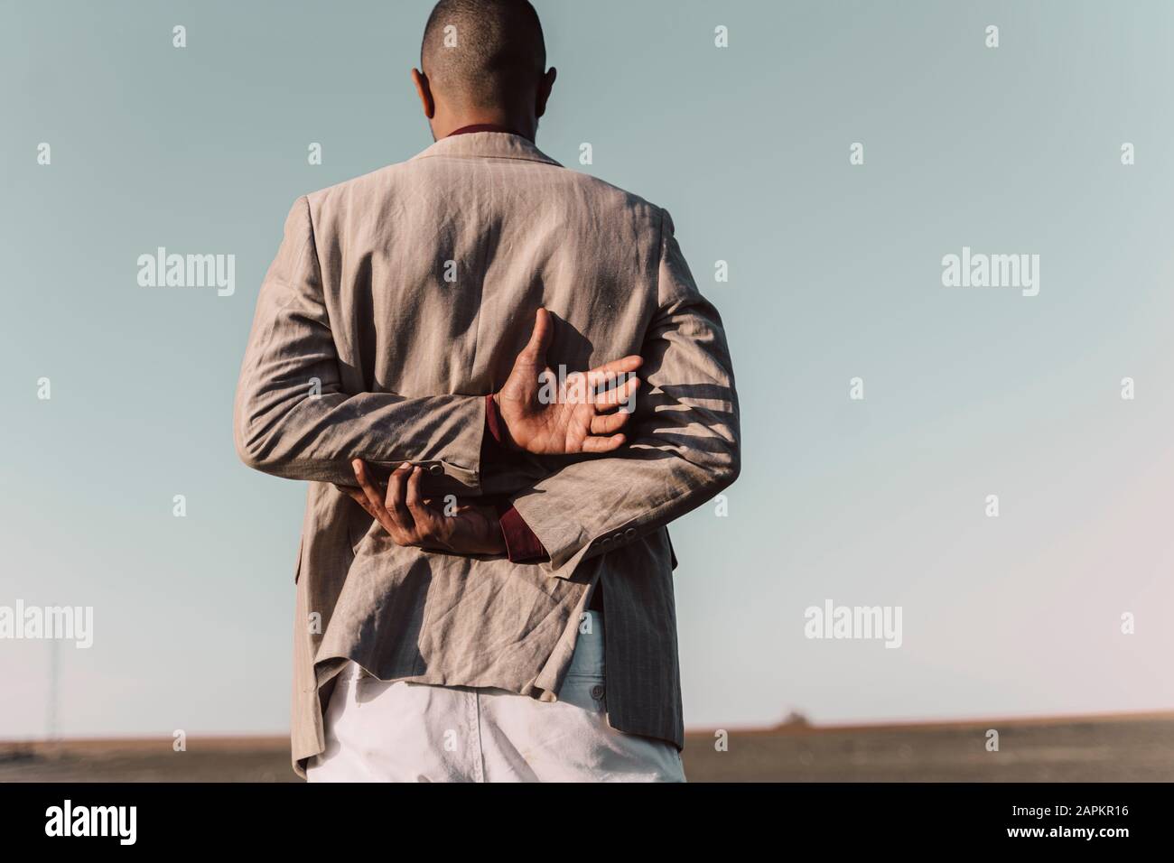 Rear view of young man standing outdoors Stock Photo - Alamy