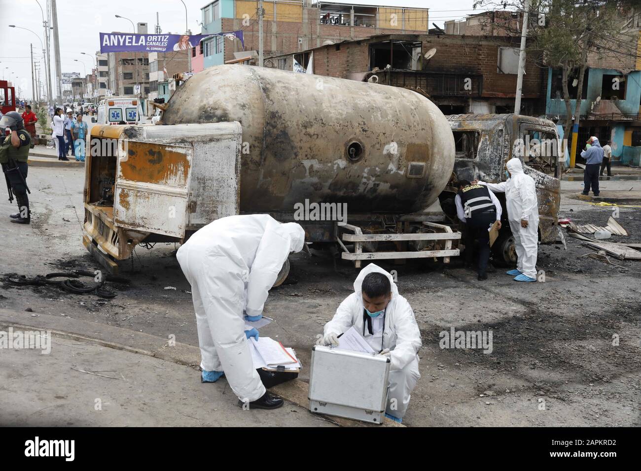 Lima, Peru. 23rd Jan, 2020. Forensic workers stand near the debris of a gas  tanker after exploded in Villa el Salvador southern Lima, Peru. A truck  carrying natural gas exploded killing at