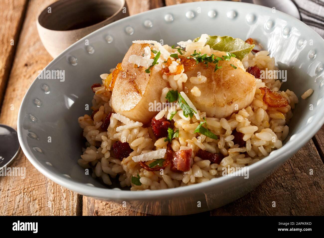 Bowl of risotto with scallops and chorizo Stock Photo Alamy