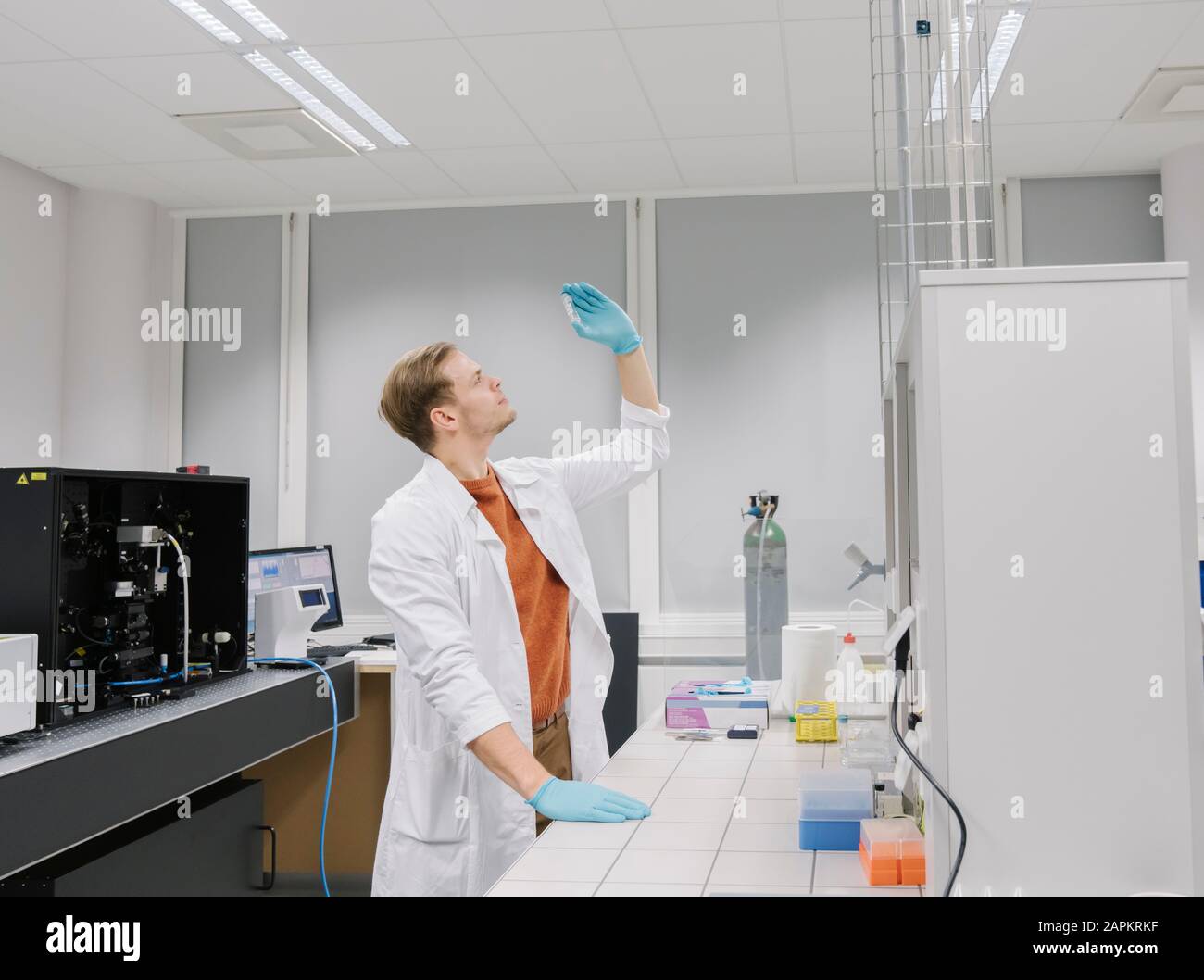 Scientist analyzing a specimen in laboratory Stock Photo Alamy