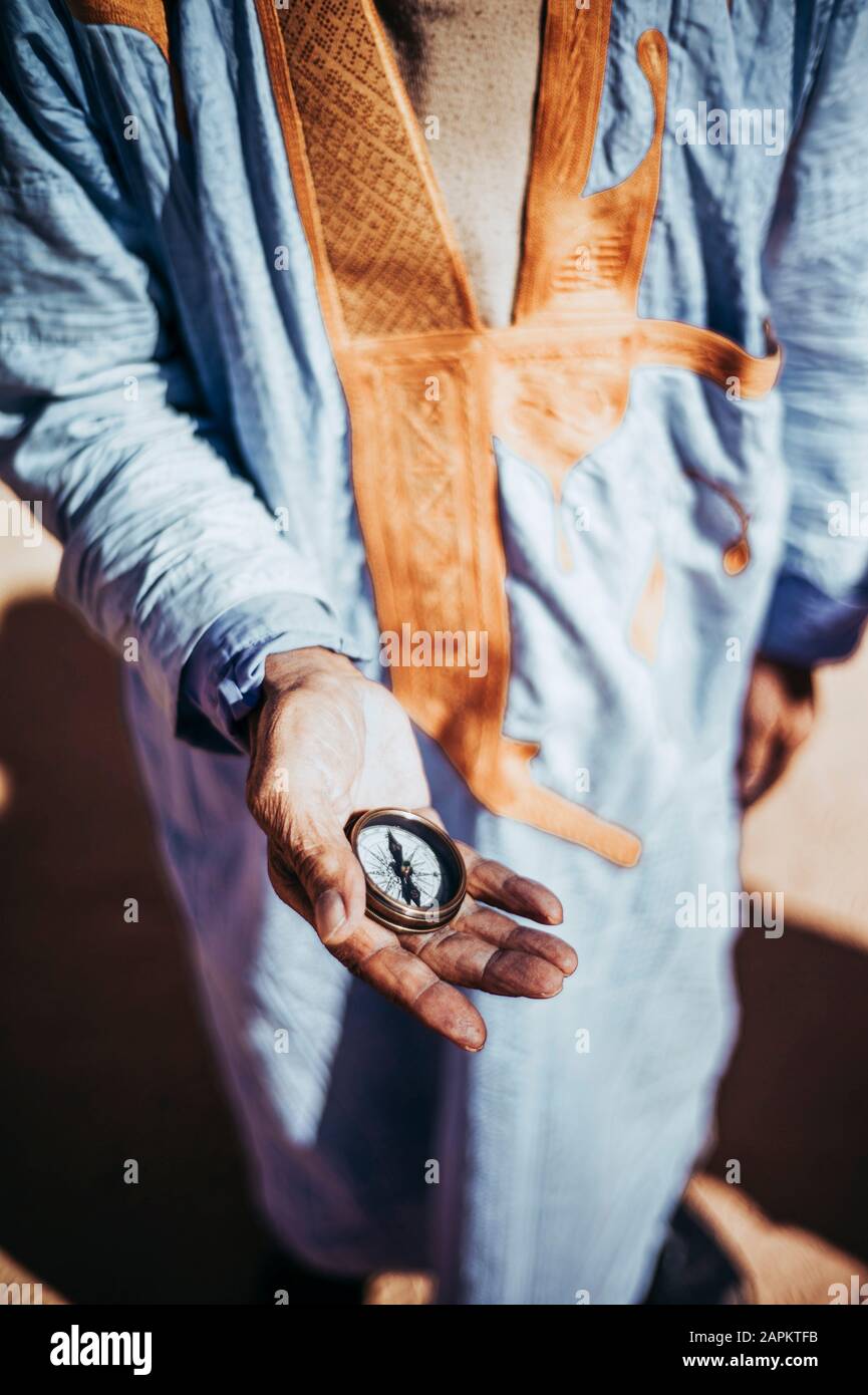 Close-up of senior man holding compass in Smara refugee camp, Tindouf, Algeria Stock Photo
