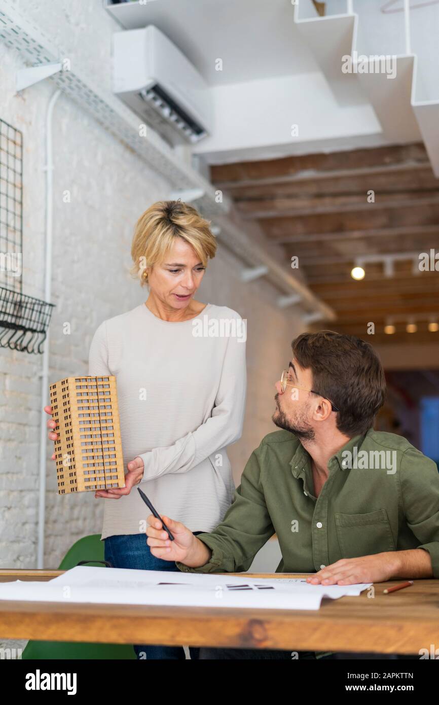 Two architects with architectural model in an office Stock Photo