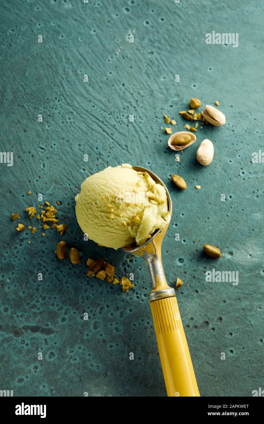 Pistachio ice cream on scoop and nuts Stock Photo Alamy