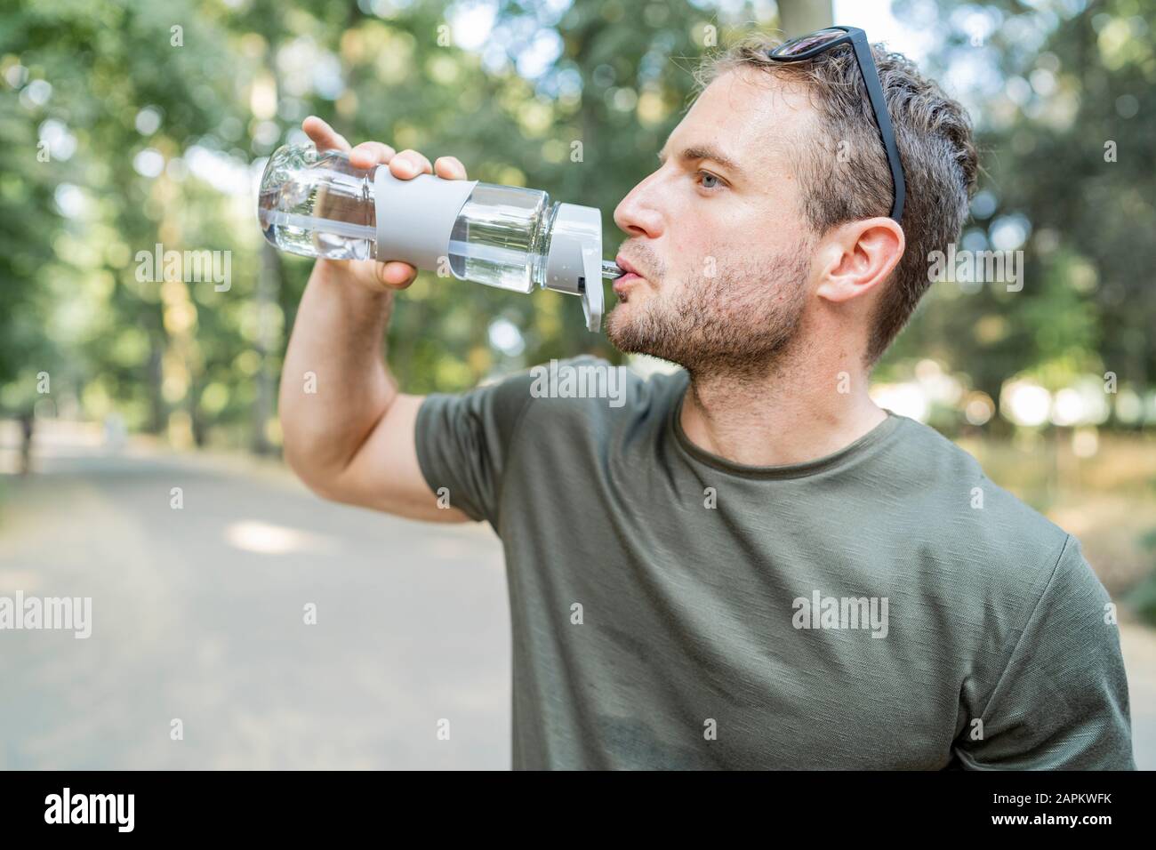 Man drinking water after workout outdoors Stock Photo