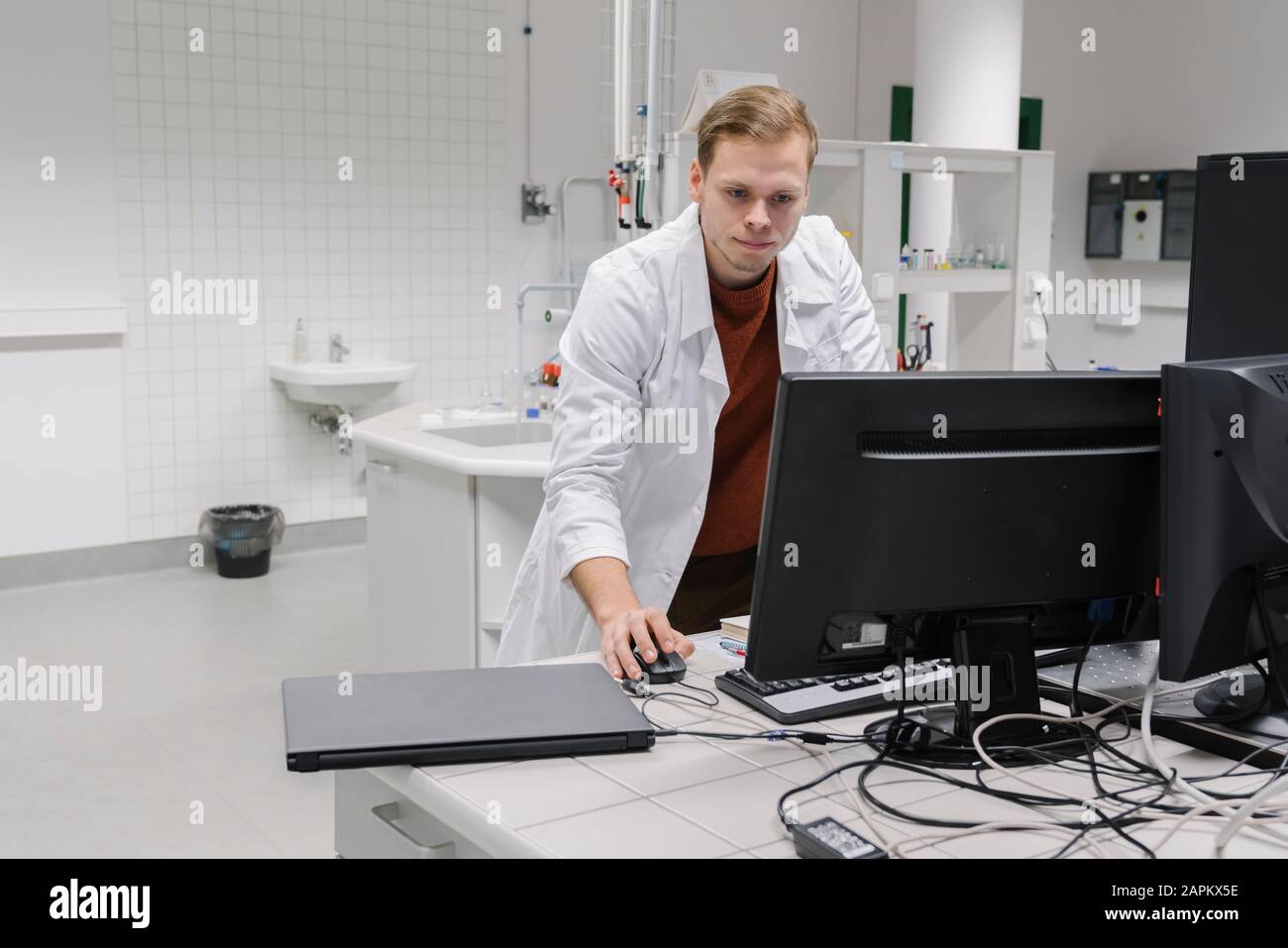 Scientist using computer in laboratory of technology center Stock Photo