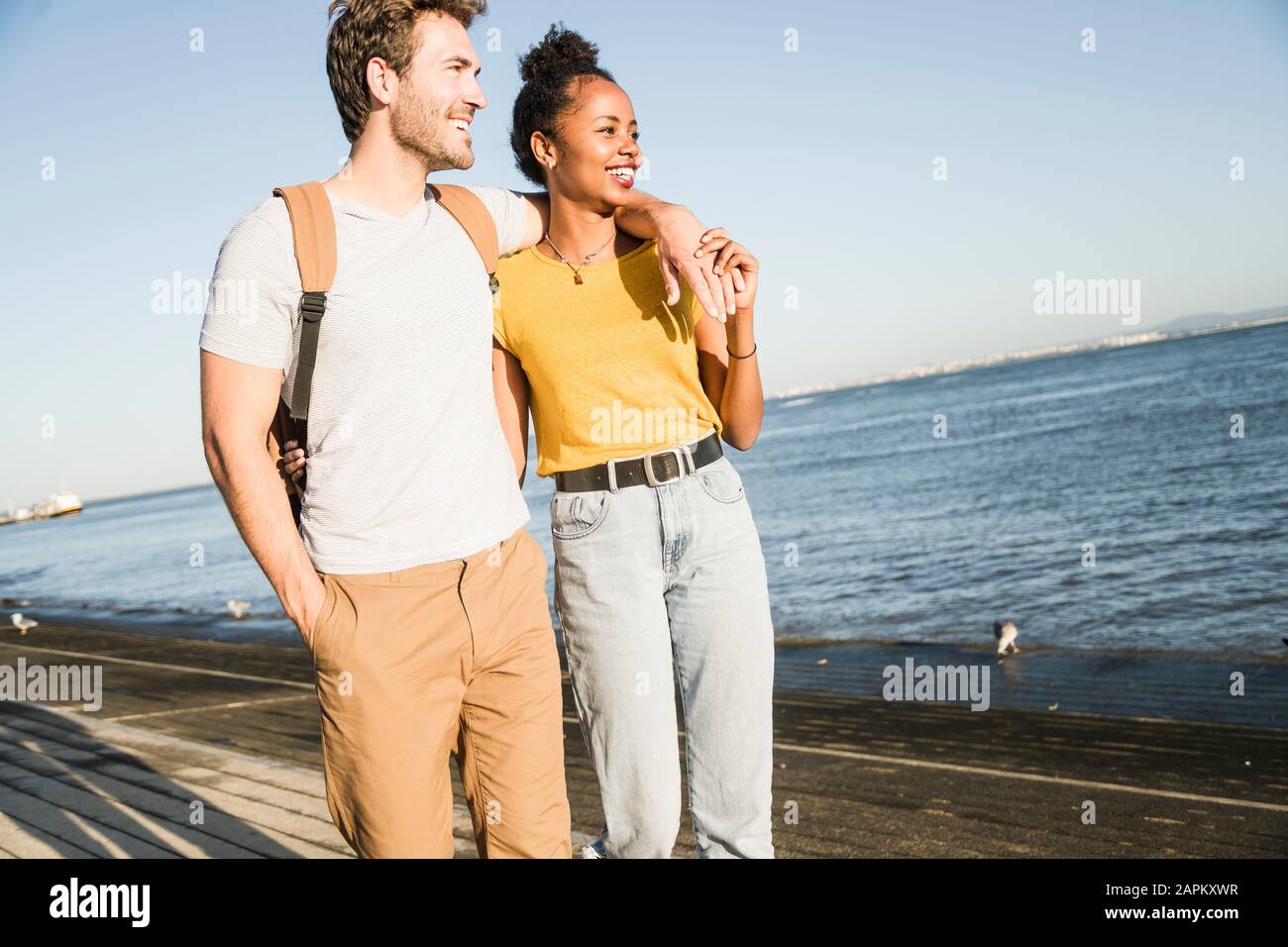 Back view couple walking arms hi-res stock photography and images - Alamy